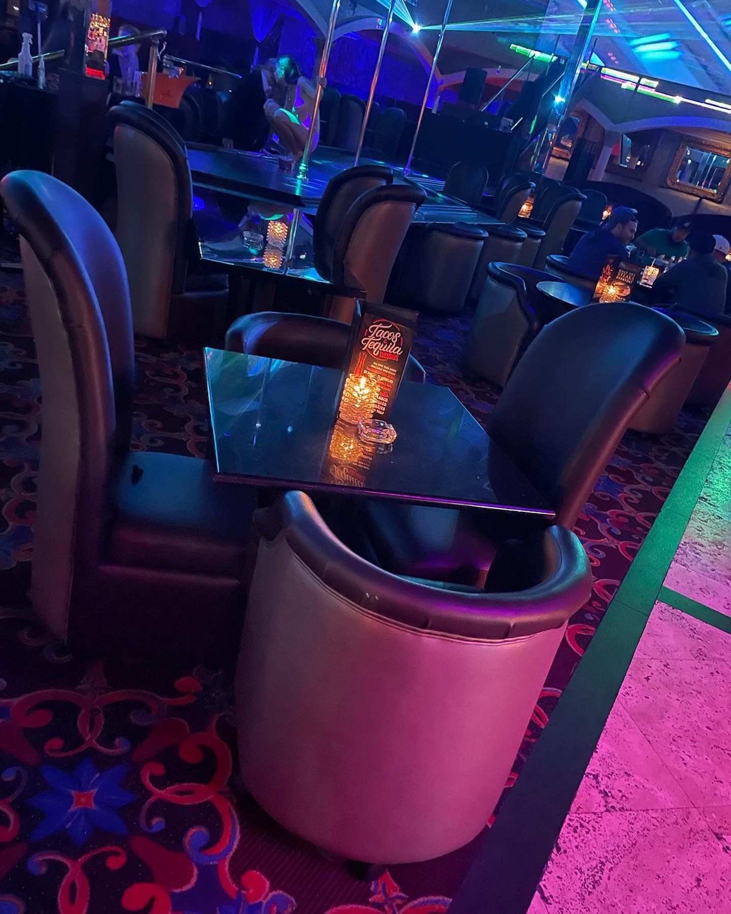 tables with parlor chairs around them in a nightclub