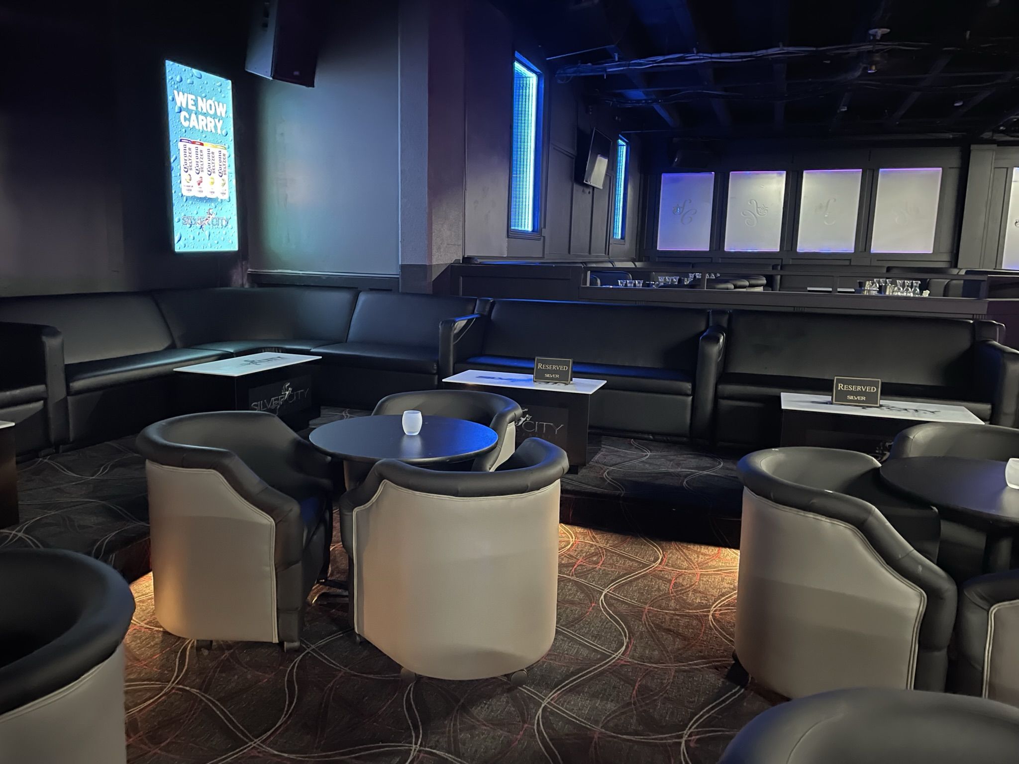 tables with parlor chairs around them in a nightclub