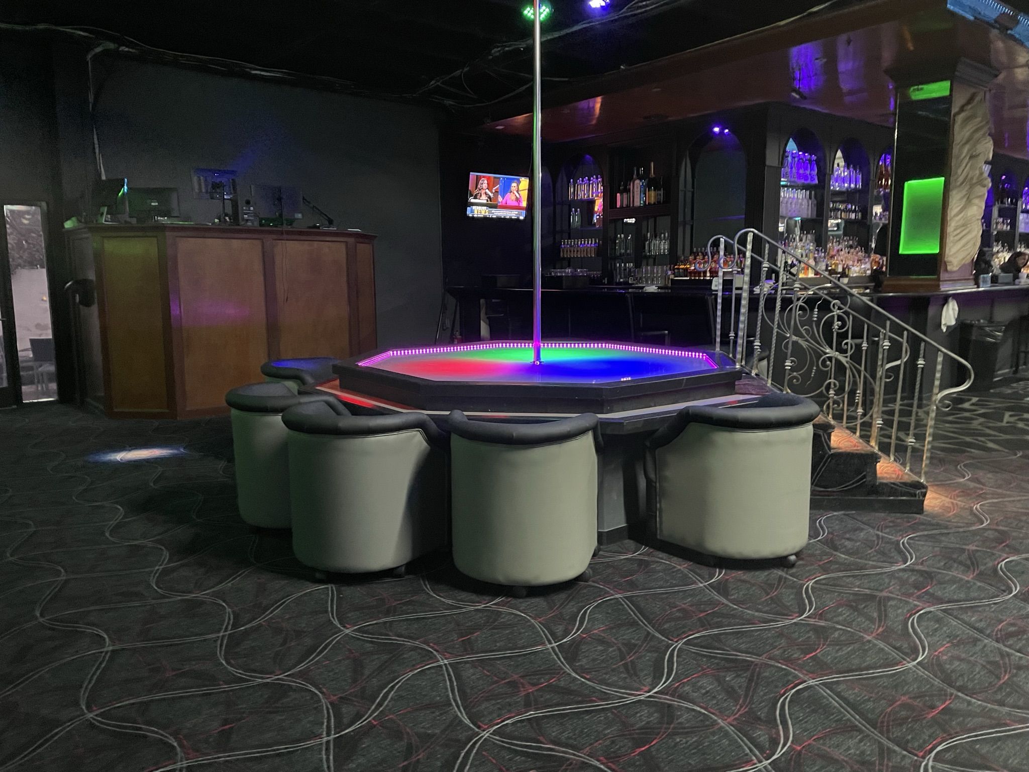 parlor chairs around a dance stage in a gentlemen's club